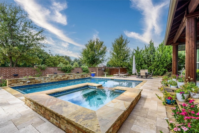 view of swimming pool with an in ground hot tub and a patio