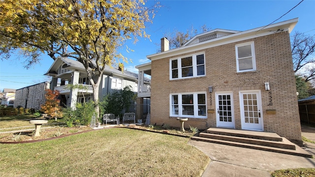 view of front of home with a front yard and a balcony