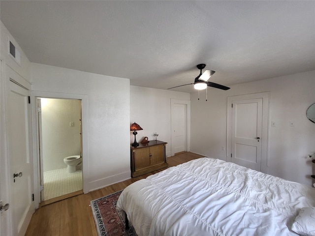 bedroom featuring hardwood / wood-style flooring, ceiling fan, and ensuite bathroom