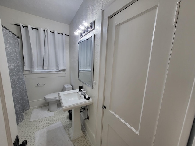 bathroom featuring tile patterned floors and toilet