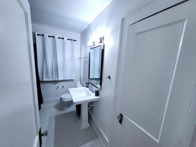 bathroom with tile patterned floors and toilet