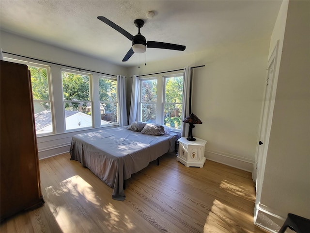 bedroom with ceiling fan, light hardwood / wood-style flooring, and pool table