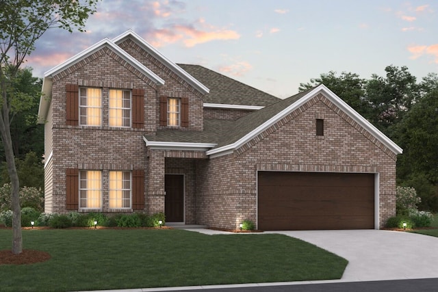 view of front facade with a yard and a garage