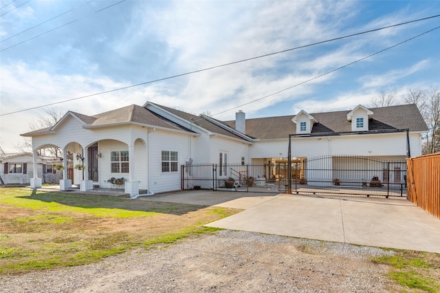 view of front of home with a front yard, a gate, roof with shingles, and fence