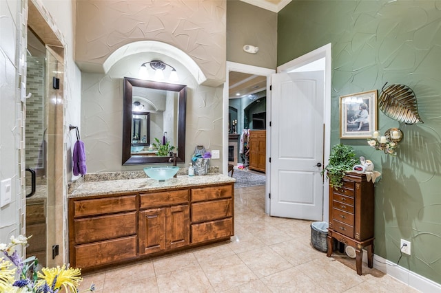 full bathroom with a shower stall, vanity, and crown molding