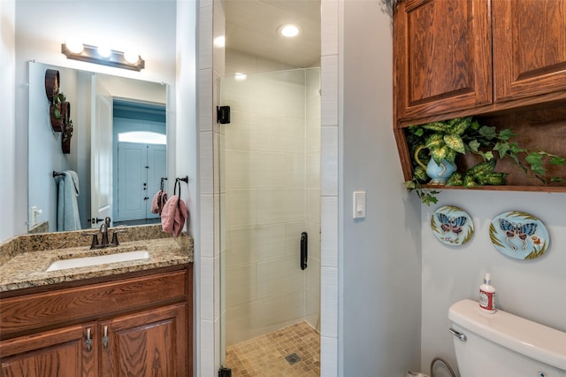 full bath with toilet, a shower stall, and vanity