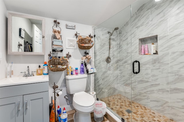 full bathroom with a shower stall, toilet, and vanity