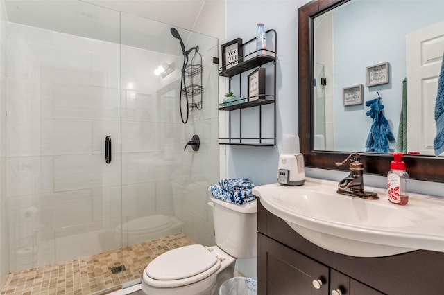 bathroom featuring a stall shower, vanity, and toilet