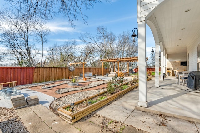 view of patio / terrace featuring a garden, a fenced backyard, and a pergola