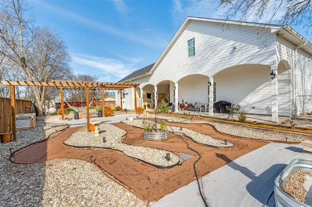 rear view of property featuring a patio, fence, and a pergola