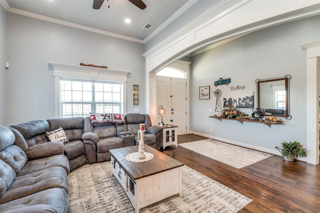 living area featuring ornamental molding, visible vents, baseboards, and wood finished floors