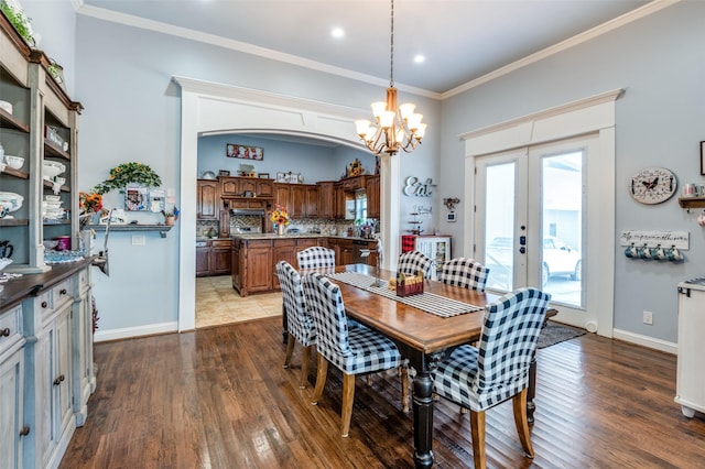 dining space featuring baseboards, french doors, dark wood-style flooring, and crown molding