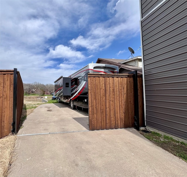 view of parking / parking lot featuring fence