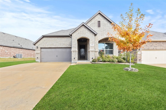 french country home featuring a front yard, central AC, and a garage