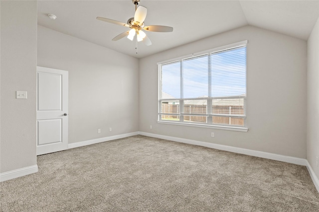 carpeted spare room with ceiling fan and lofted ceiling