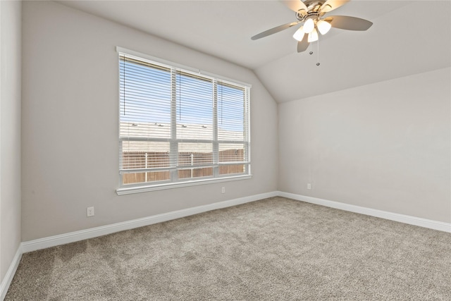 carpeted empty room featuring ceiling fan and lofted ceiling