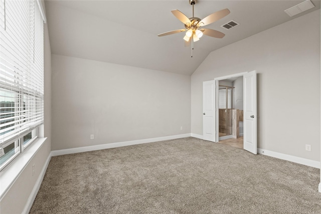 unfurnished bedroom with light carpet, ceiling fan, and vaulted ceiling