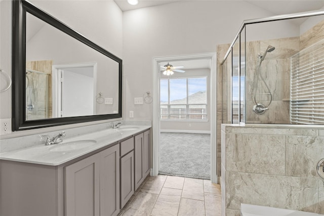 bathroom with vanity, vaulted ceiling, a shower with door, and ceiling fan