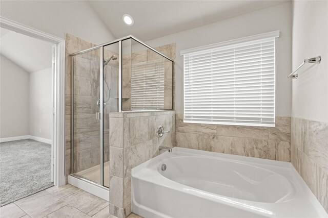 bathroom with separate shower and tub, tile patterned flooring, and lofted ceiling