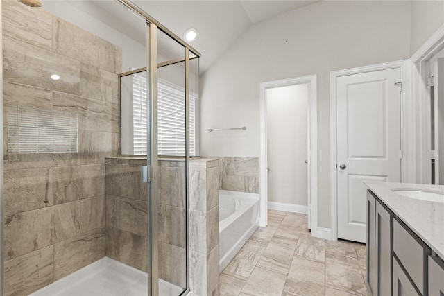 bathroom with vanity, separate shower and tub, and vaulted ceiling