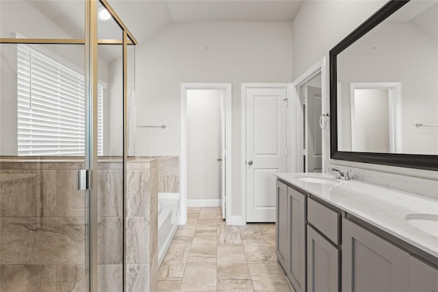 bathroom featuring vanity, lofted ceiling, and independent shower and bath