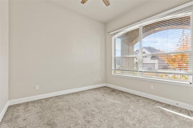 carpeted empty room featuring ceiling fan