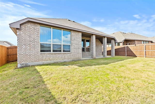 rear view of property with a lawn