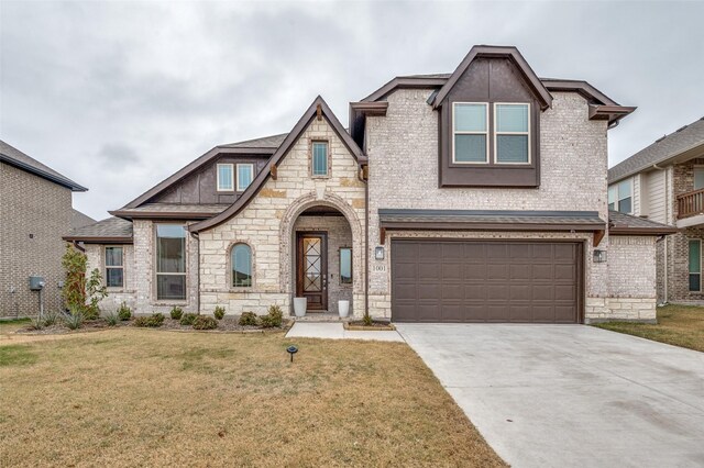 view of front of property with a garage and a front lawn