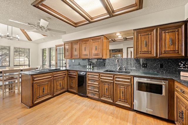 kitchen featuring kitchen peninsula, a textured ceiling, backsplash, and sink