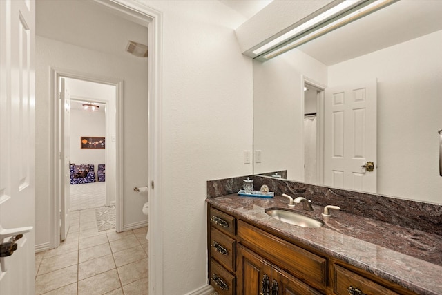 bathroom featuring toilet, vanity, and tile patterned floors