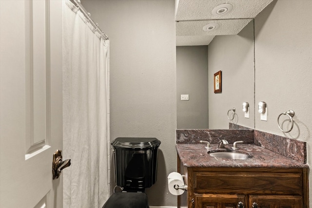 bathroom featuring vanity and a textured ceiling