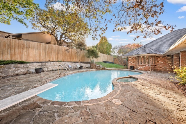 view of swimming pool with a patio area, an in ground hot tub, and a diving board