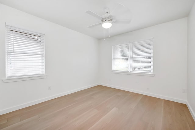 empty room featuring ceiling fan and light hardwood / wood-style flooring