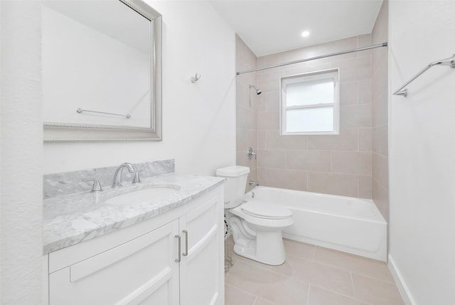 full bathroom featuring tile patterned flooring, vanity, toilet, and tiled shower / bath