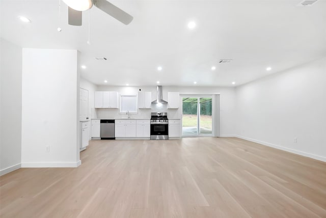 unfurnished living room with ceiling fan and light hardwood / wood-style floors