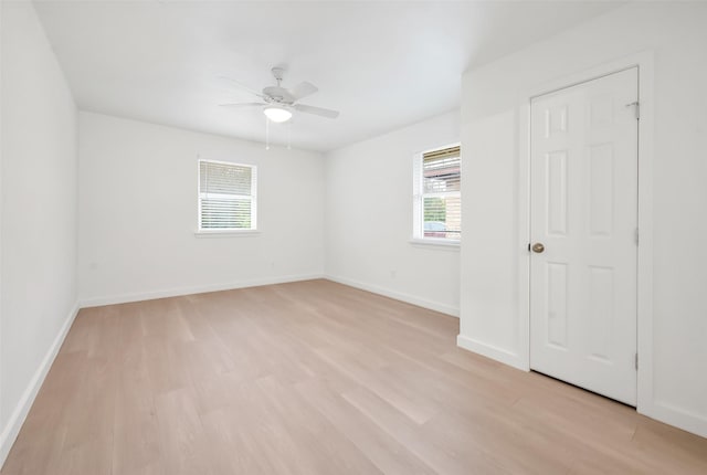 empty room featuring ceiling fan and light wood-type flooring