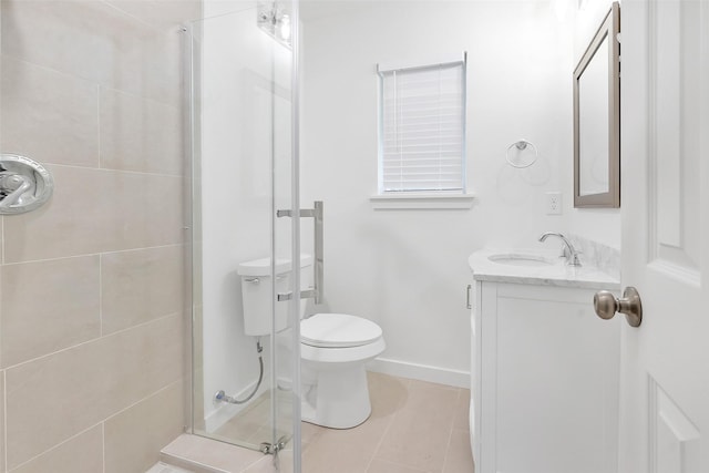 bathroom featuring tile patterned floors, a shower with door, vanity, and toilet