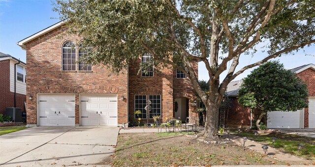 view of front facade featuring central AC unit and a garage