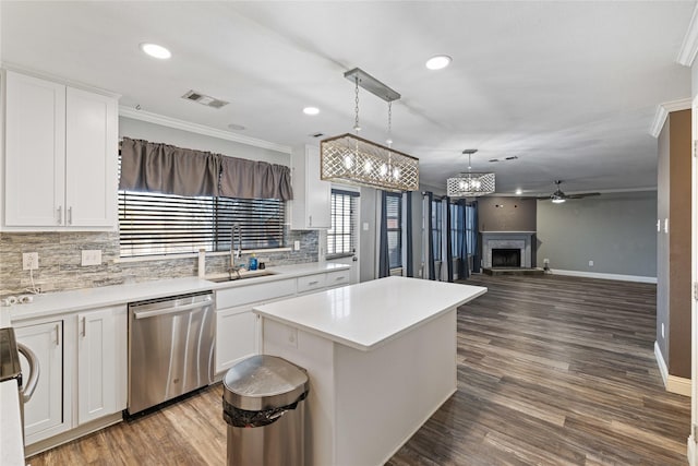 kitchen with white cabinets, ceiling fan, sink, dishwasher, and a kitchen island