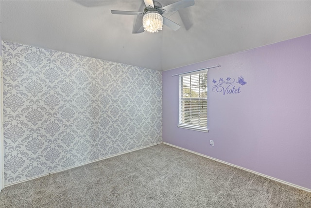 carpeted spare room with lofted ceiling and ceiling fan