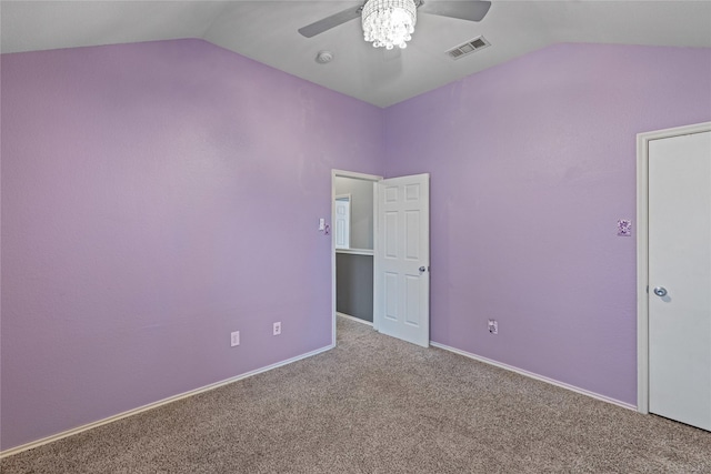 unfurnished bedroom with ceiling fan, lofted ceiling, and carpet