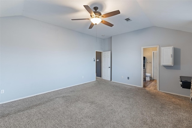 unfurnished bedroom featuring carpet flooring, ceiling fan, lofted ceiling, and ensuite bath