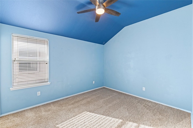 carpeted spare room with lofted ceiling and ceiling fan