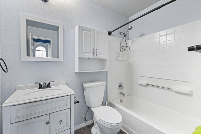 full bathroom featuring a textured ceiling, vanity, toilet, and shower / washtub combination