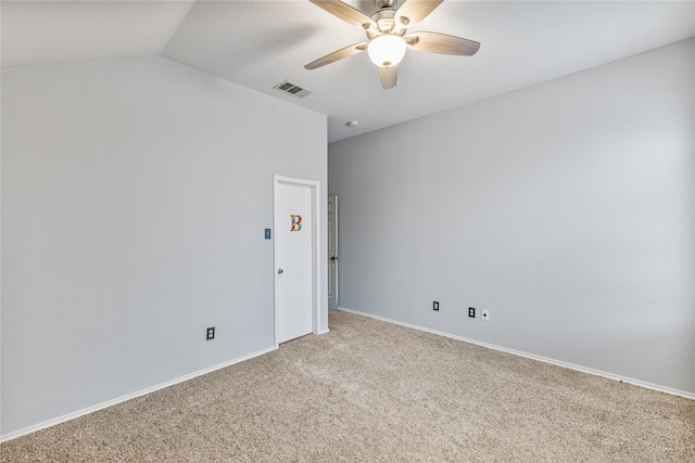 spare room featuring ceiling fan, carpet, and lofted ceiling