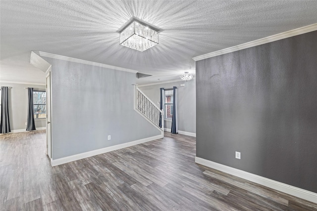 unfurnished room featuring a notable chandelier, crown molding, wood-type flooring, and a textured ceiling