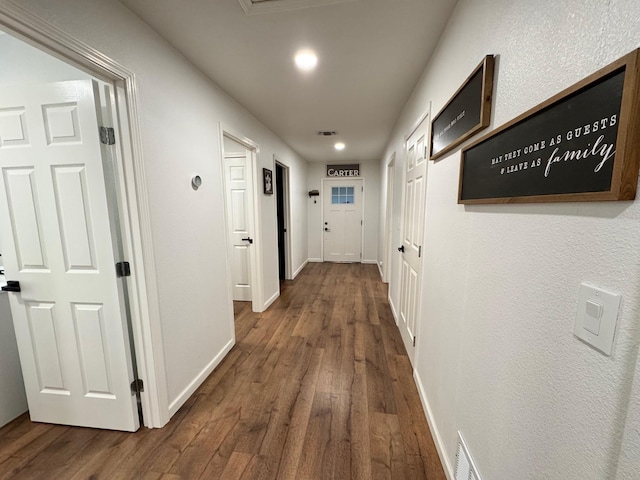 corridor with hardwood / wood-style floors