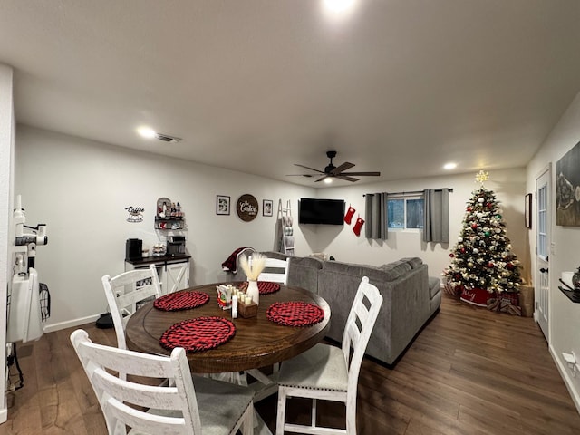 dining space featuring ceiling fan and dark hardwood / wood-style flooring