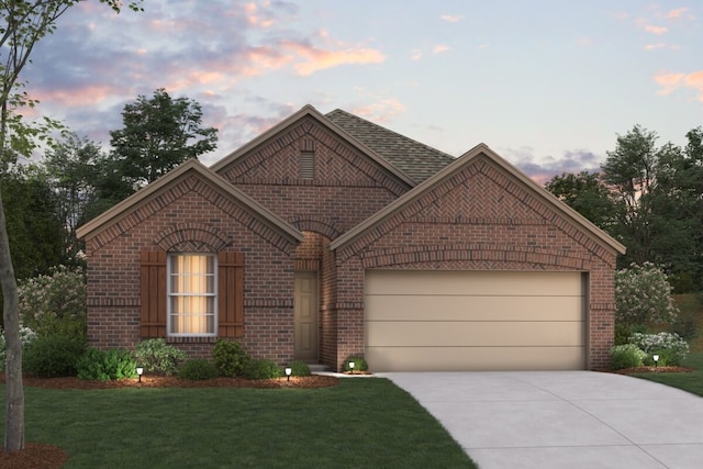 view of front of property with a garage and a yard