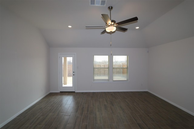 spare room with dark wood finished floors, visible vents, vaulted ceiling, and baseboards